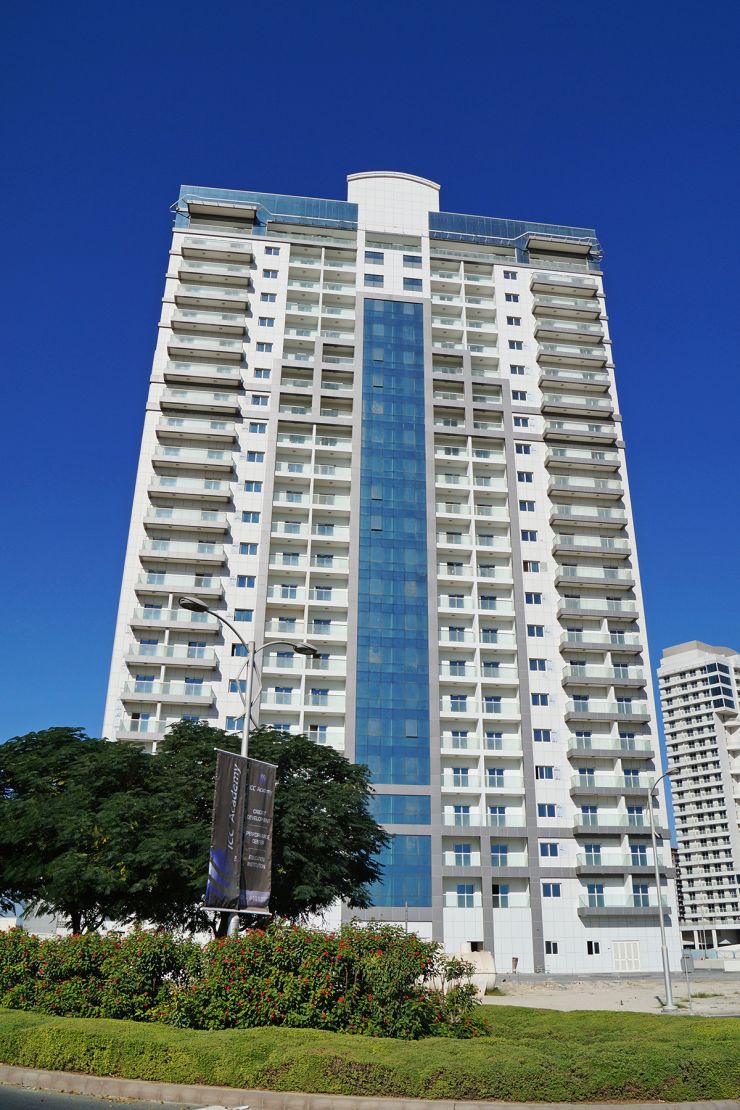 High-rise Red Residence tower with glass balconies, premier real estate listing for investors and home buyers.