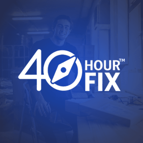 Two men reviewing documents together by a large window, with sunlight streaming in.