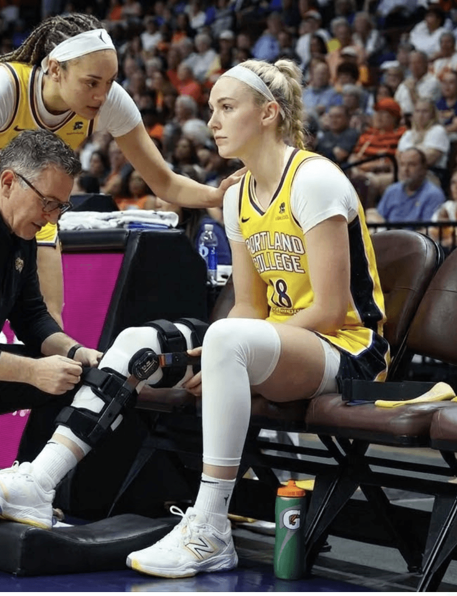 Basketball player with ACL injury on bench