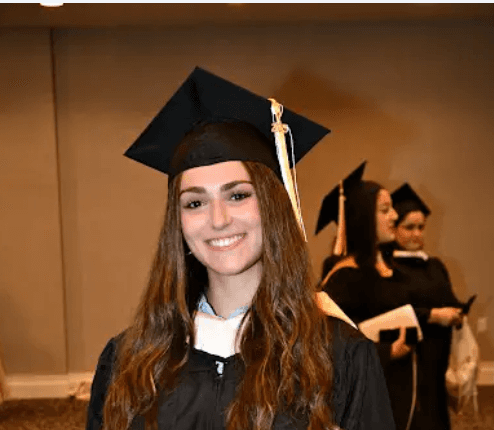 four people watching on white MacBook on top of glass-top table