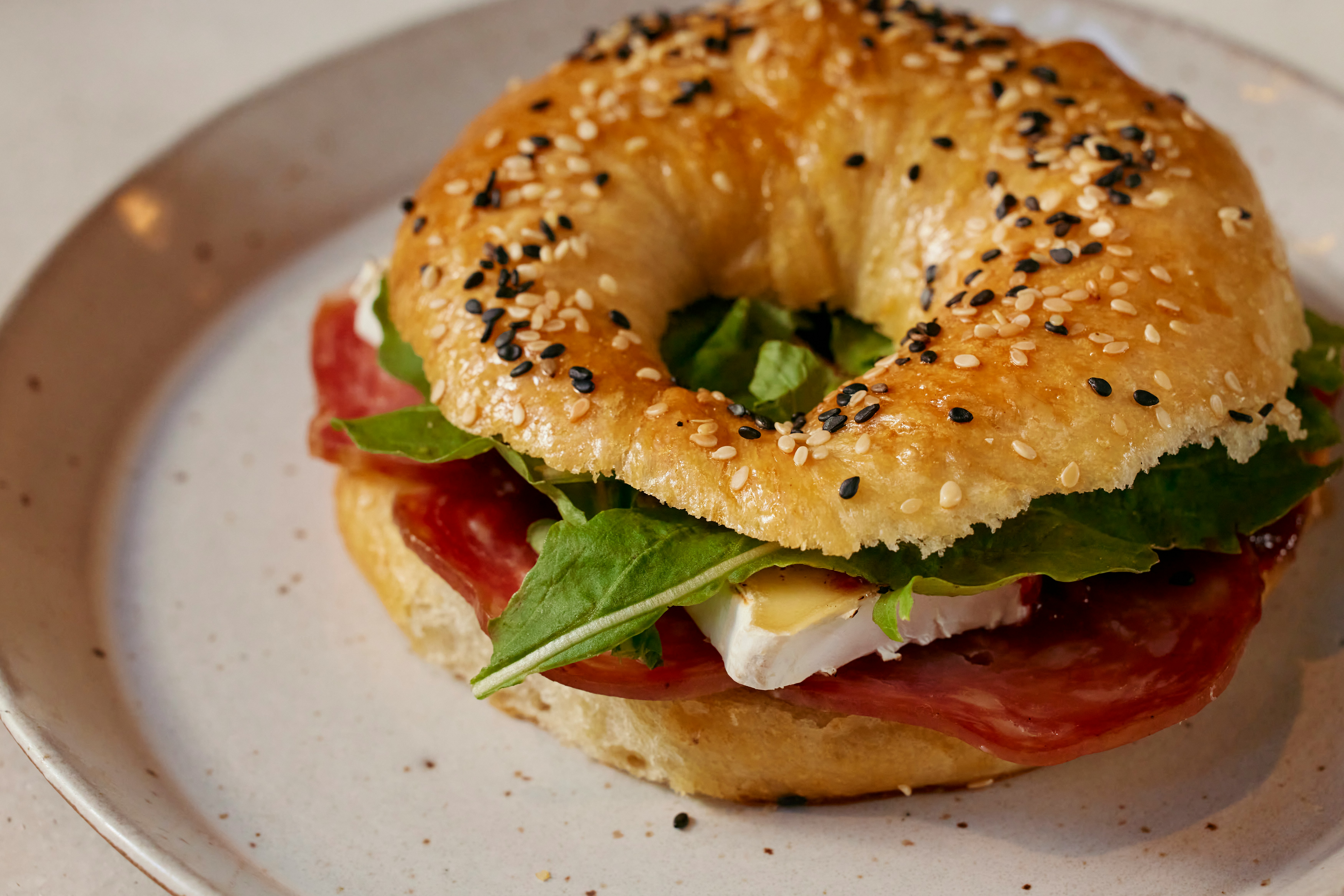 Bagel sandwich served on a plate.