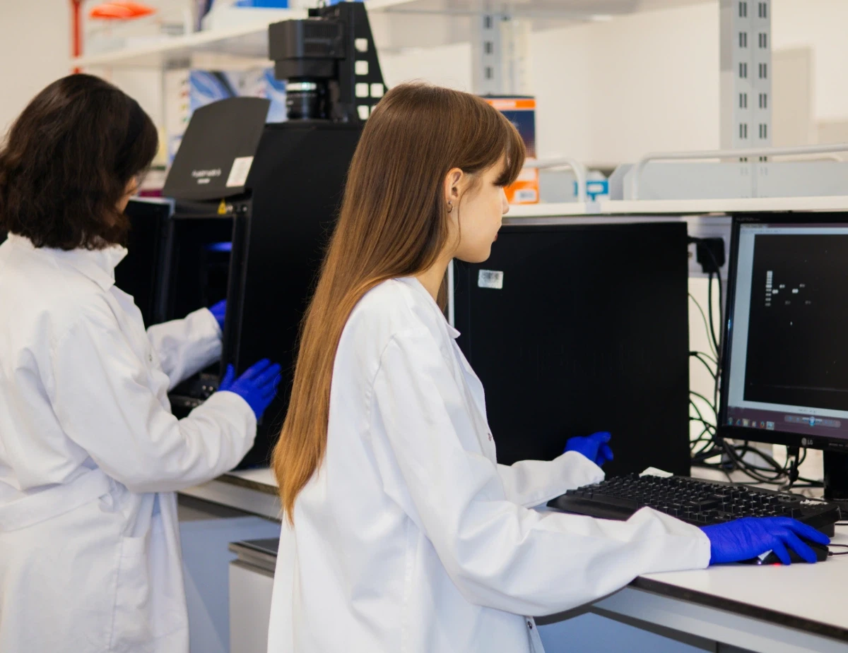 Two scientists working on computers in a laboratory.