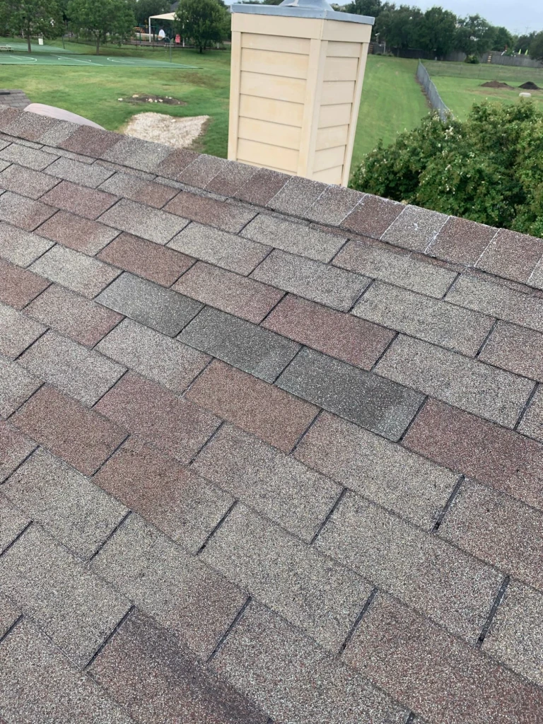 Repaired shingle area near the chimney in Cibolo, Texas.