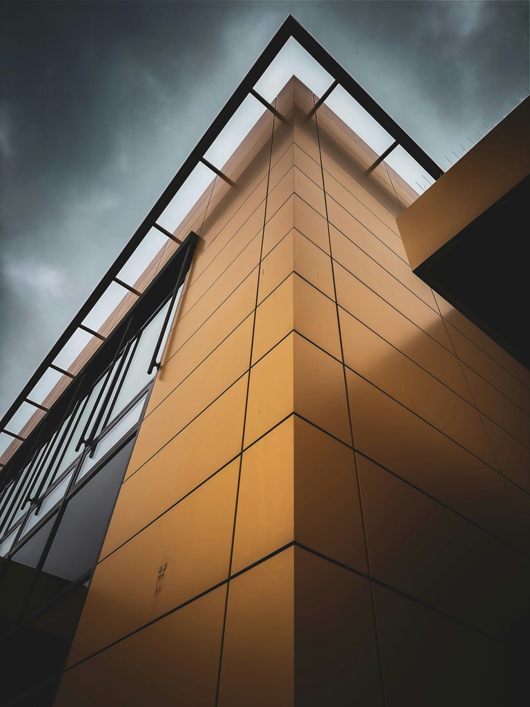 a tall building with a sky in the background