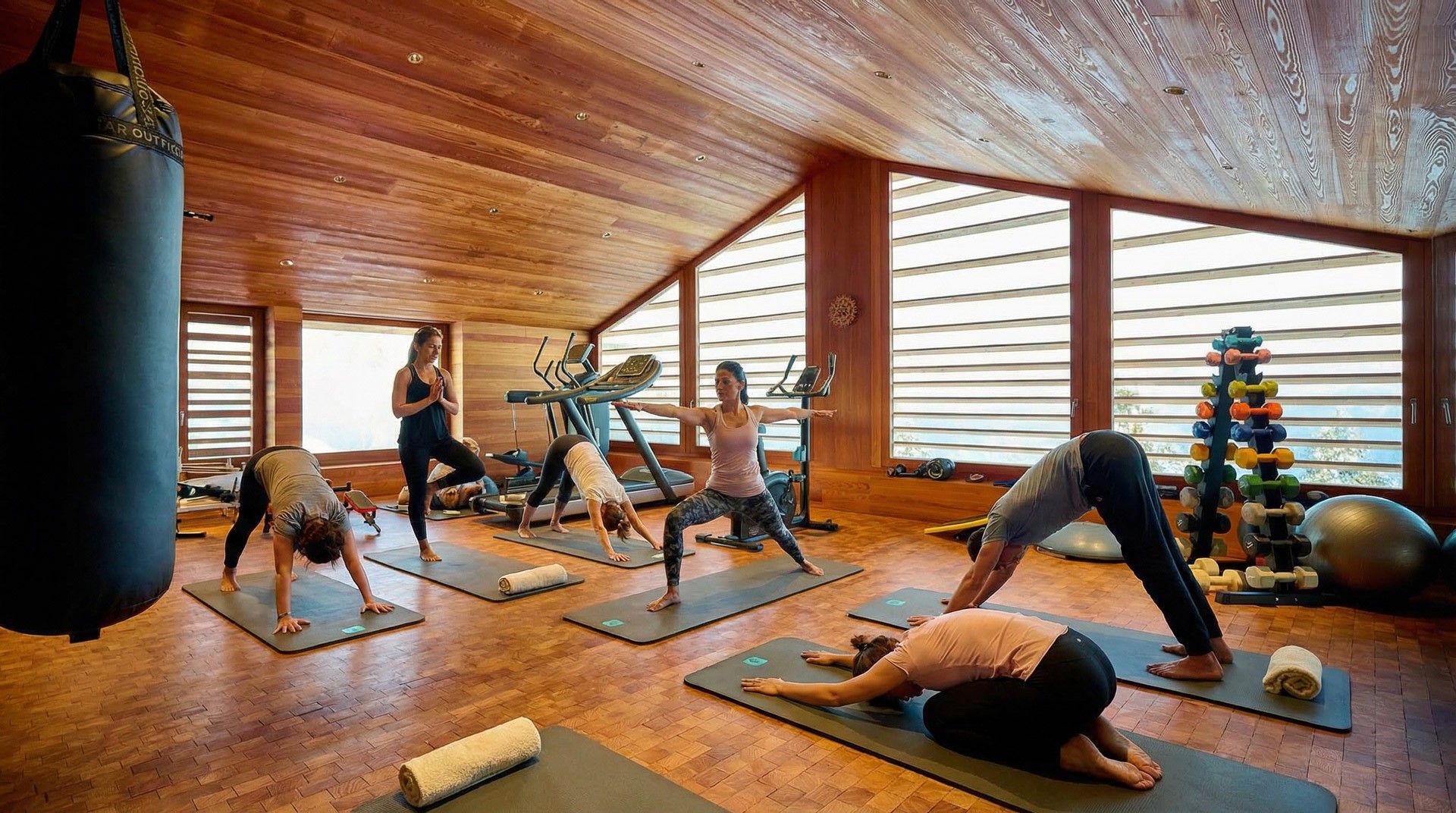 A group of people praticing yoga on the beach in the morning