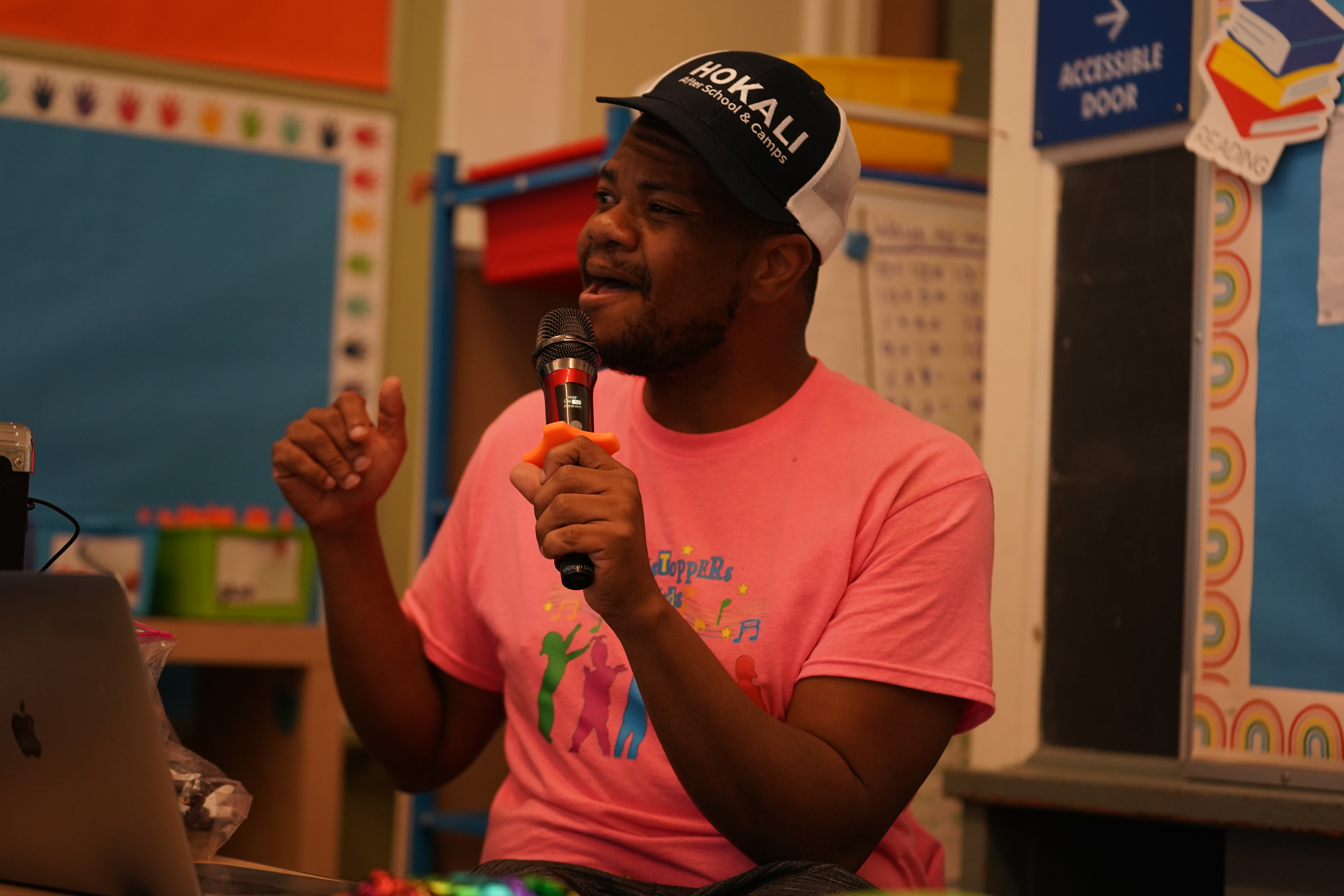 Drama instructor guiding students through choreography in musical theater rehearsal