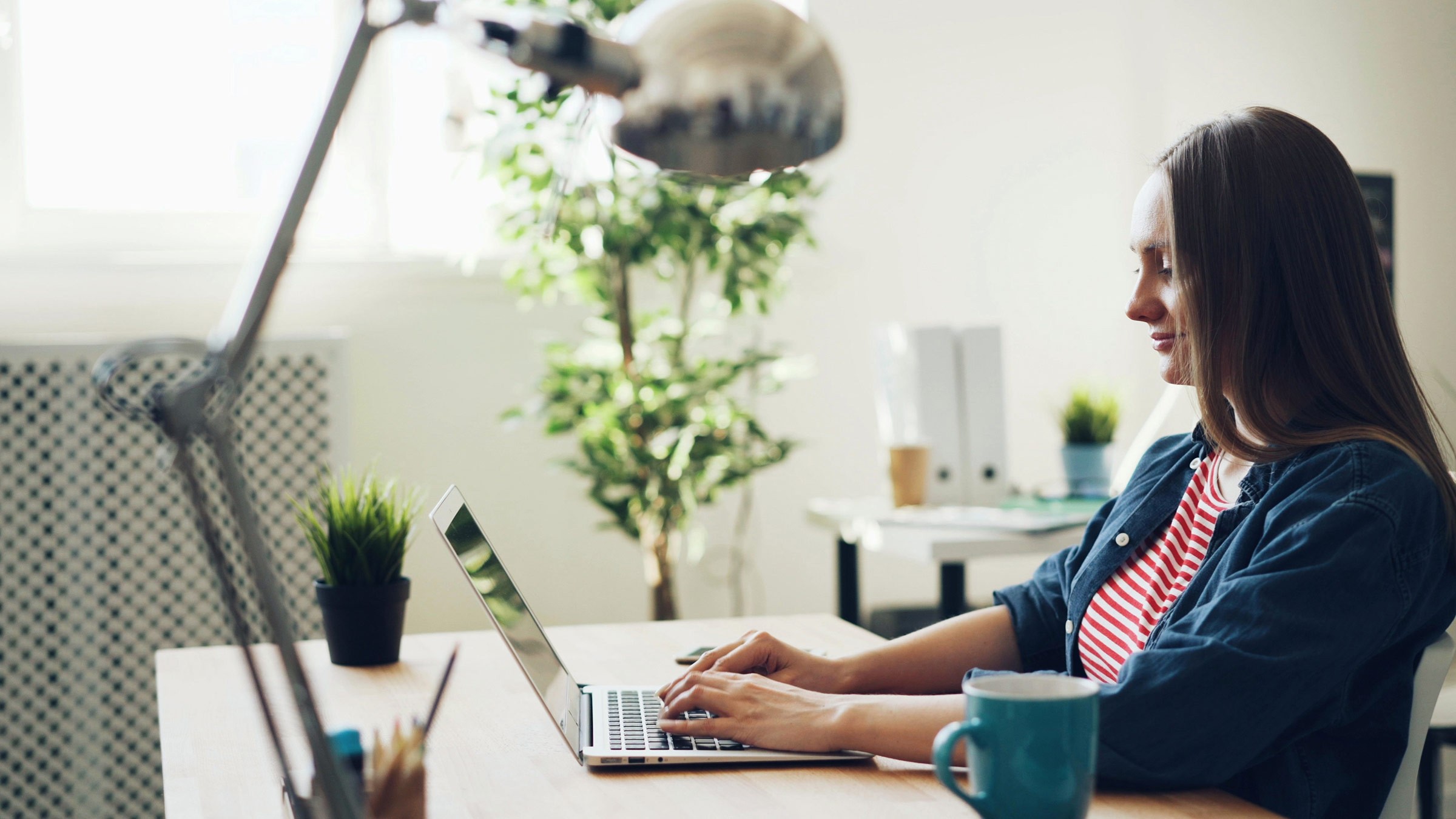 Woman working on laptop.