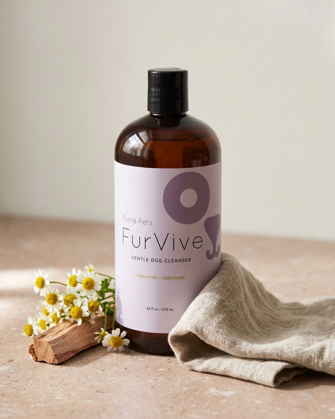 FurVive gentle dog cleanser bottle with chamomile flowers, cedarwood, and linen cloth.