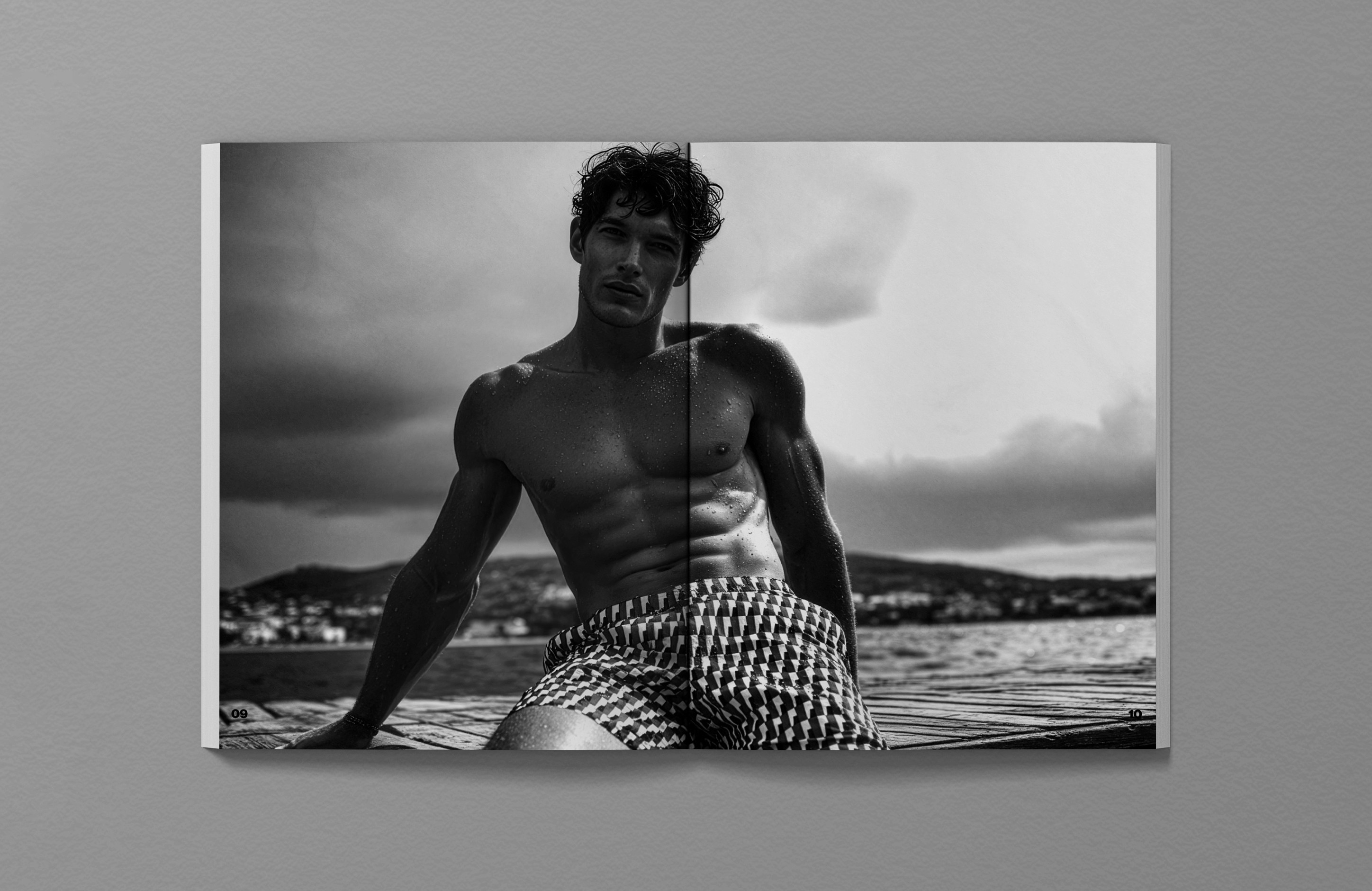 Hugo Boss SS26 Elevated Calm editorial, model wearing Coastal Weave geometric print swim shorts on coastal dock