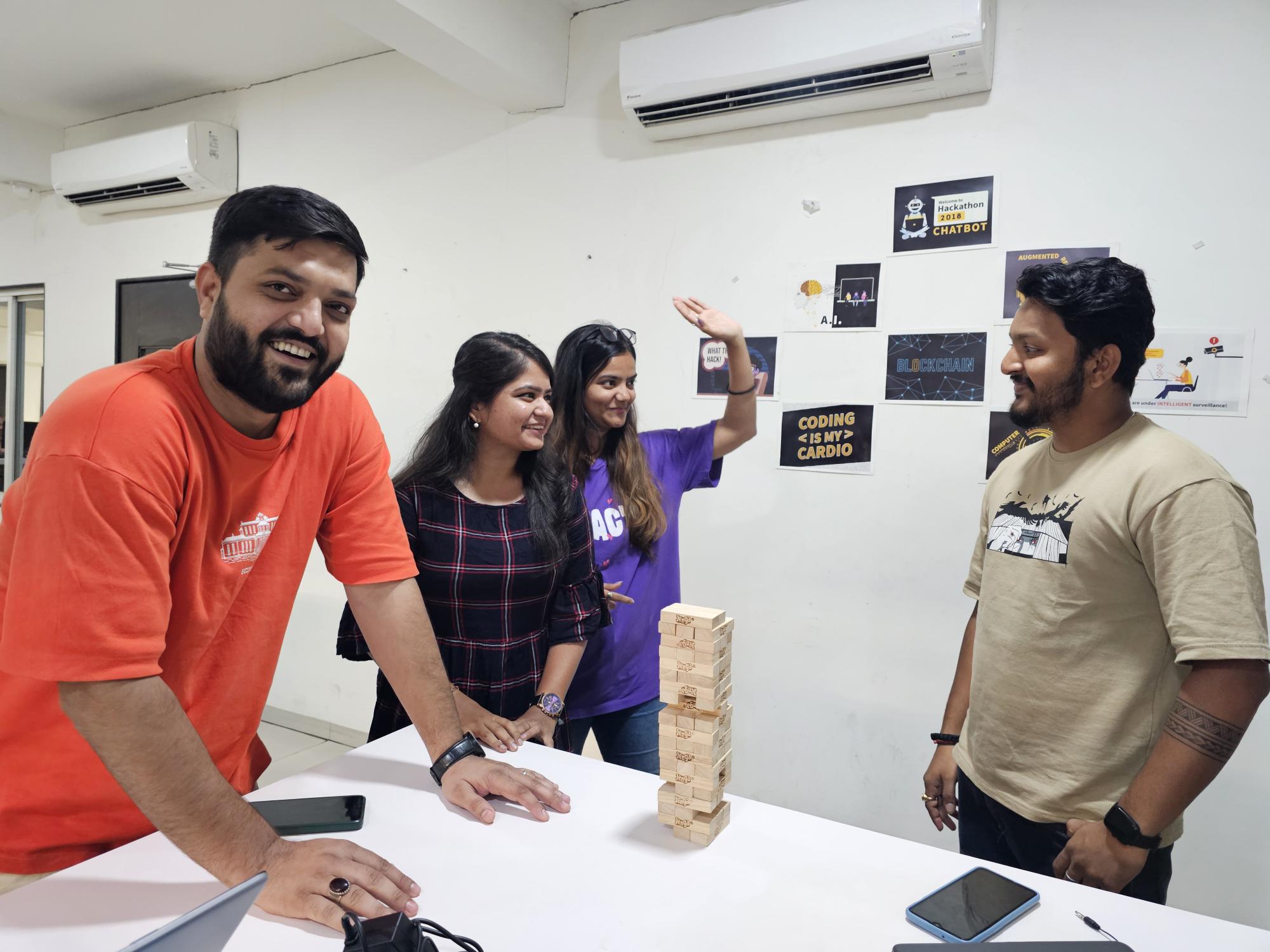 Team members celebrating a milestone with high-fives and smiles