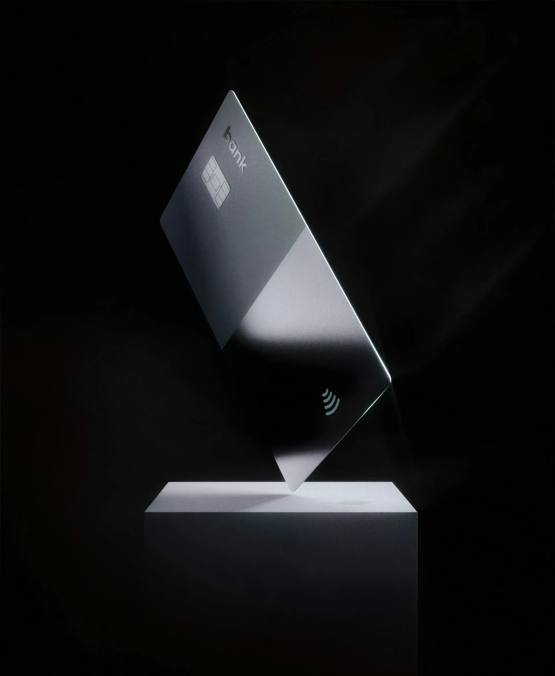 Modern dark gray bank card with chip and contactless symbol.