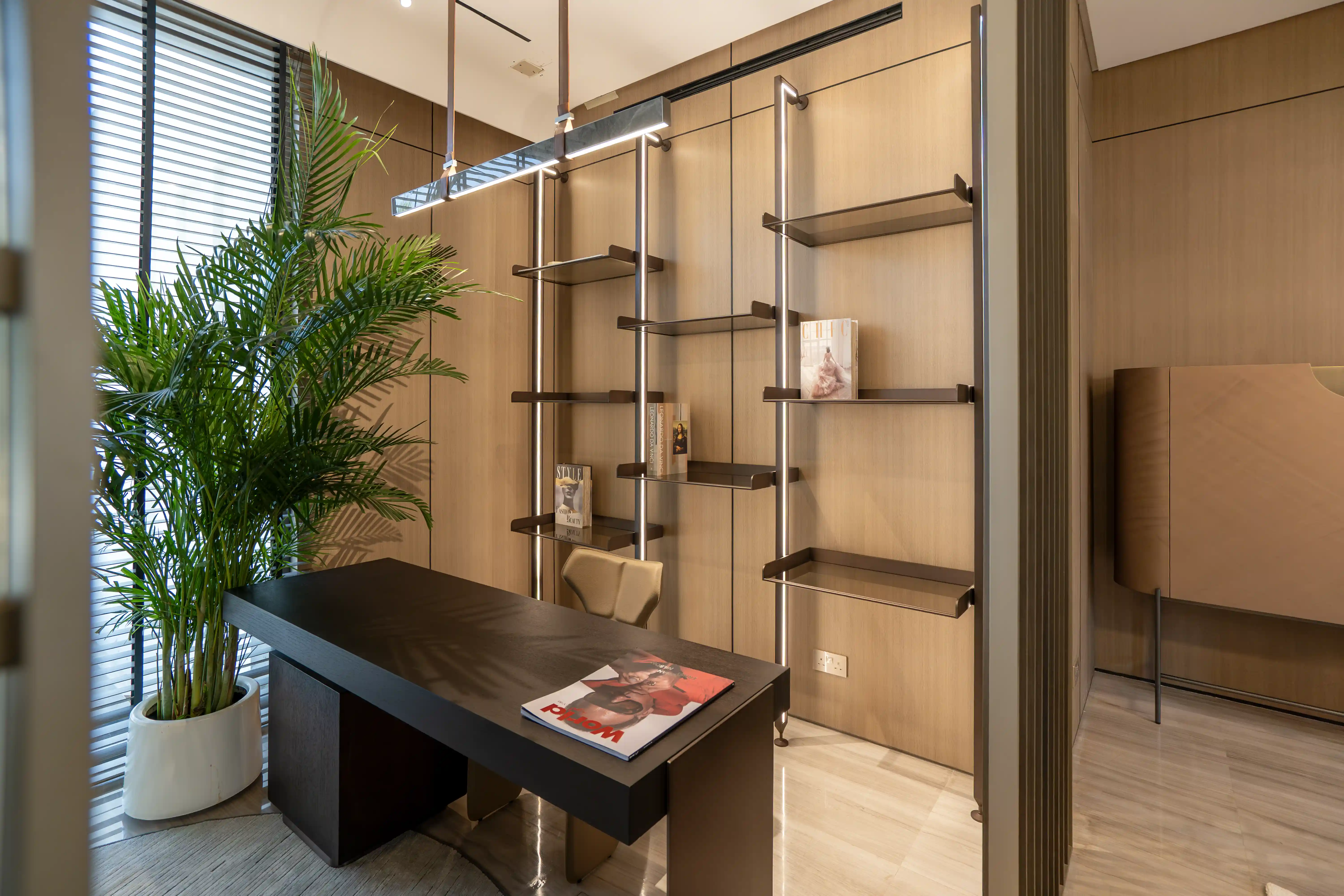 Study/office area with a display unit and a chandelier.