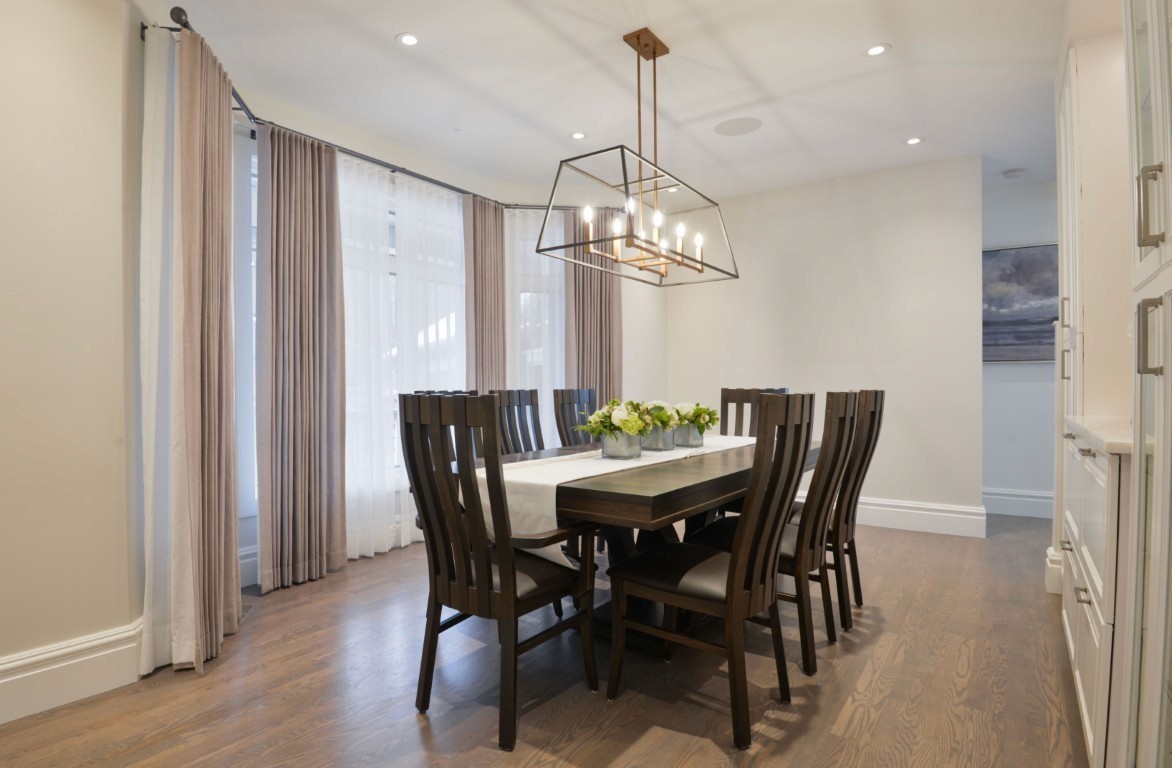 Image of Luxury dining room design with modern furniture, window coverings, and layout design by KHD Homes.