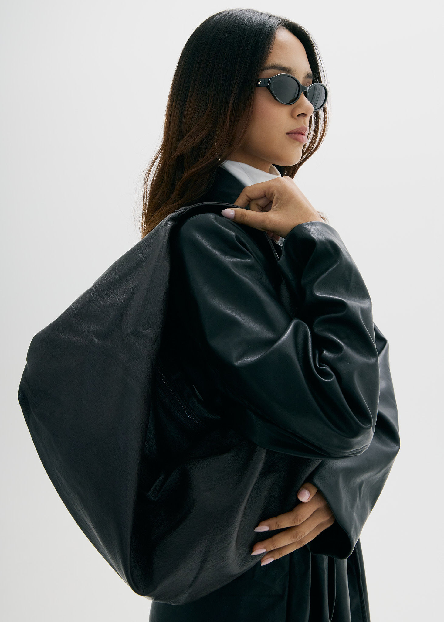 Woman walking on a curved pavement with shadow.