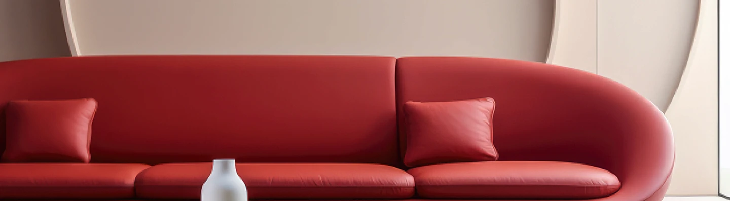 Modern minimalist living room with a red curved sofa and glass coffee table.
