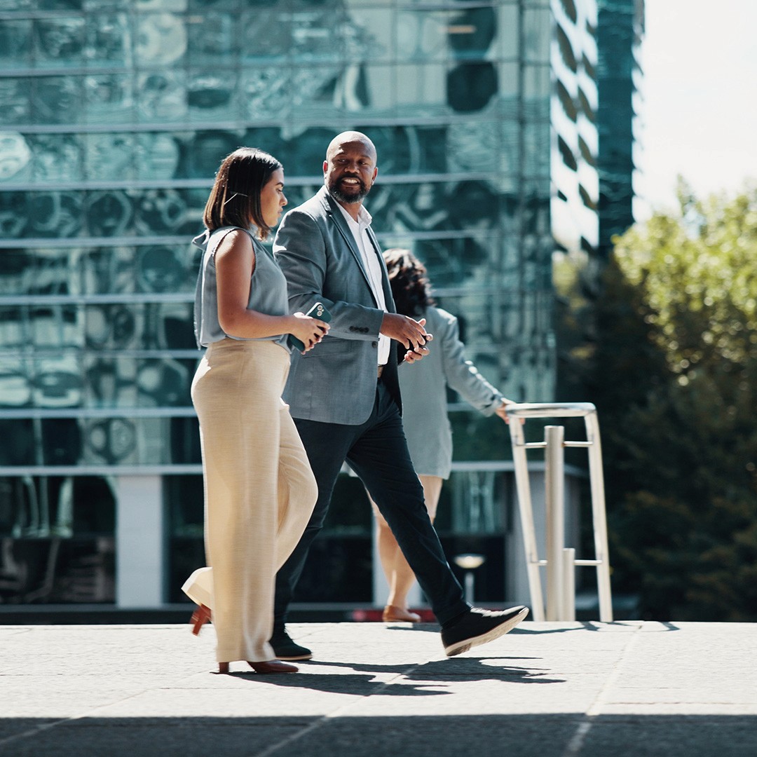Security professionals walking through London discussing in front of a building