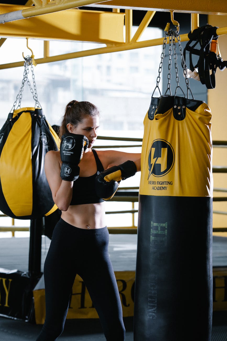 A man working out by using punching bags