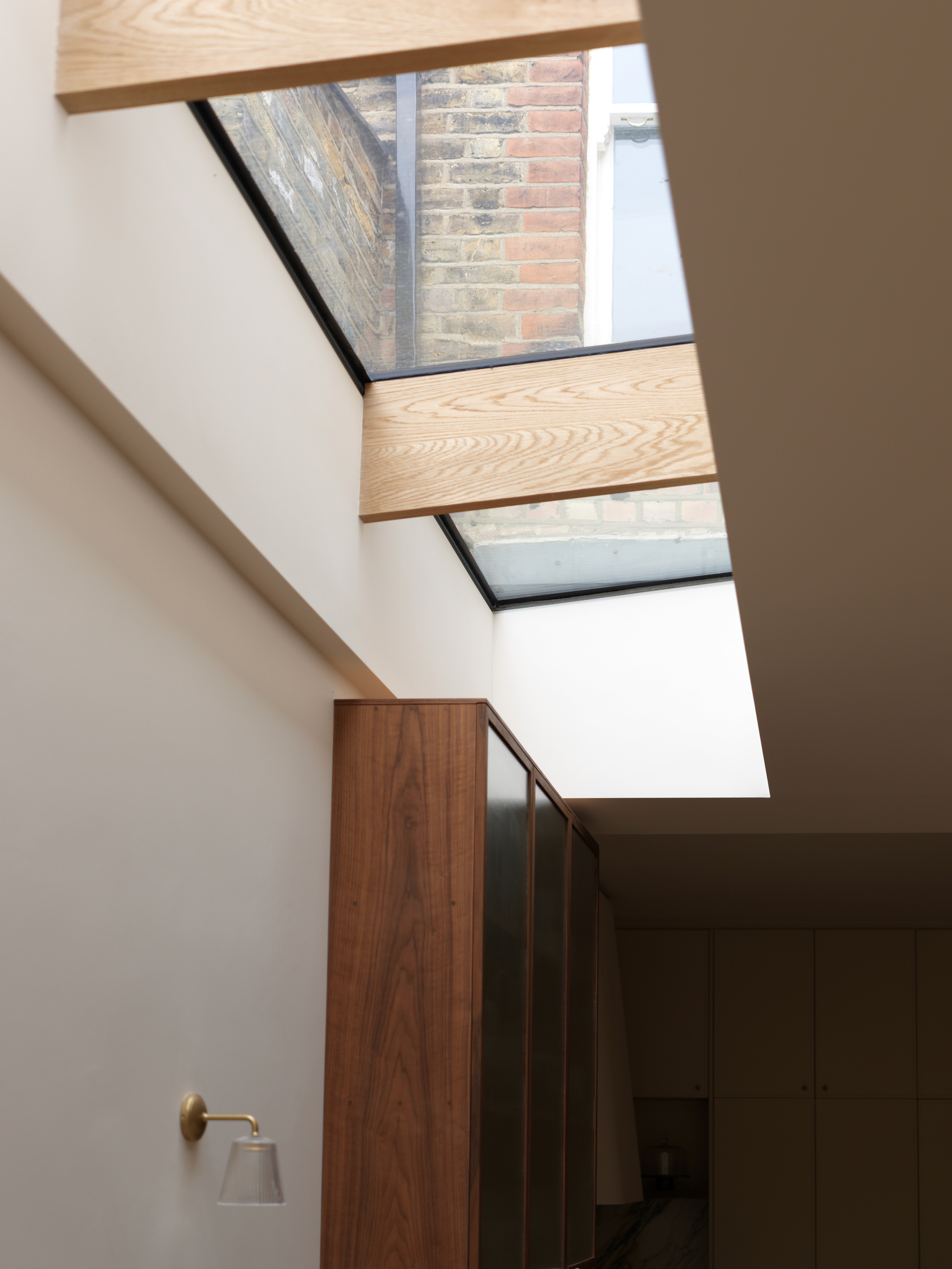 architectural rooflight above and warm timber balustrade detail