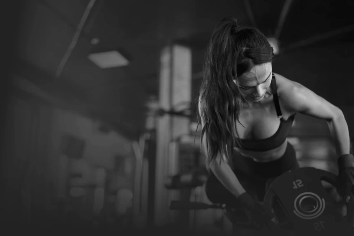 Woman lifting dumbbells at the gym