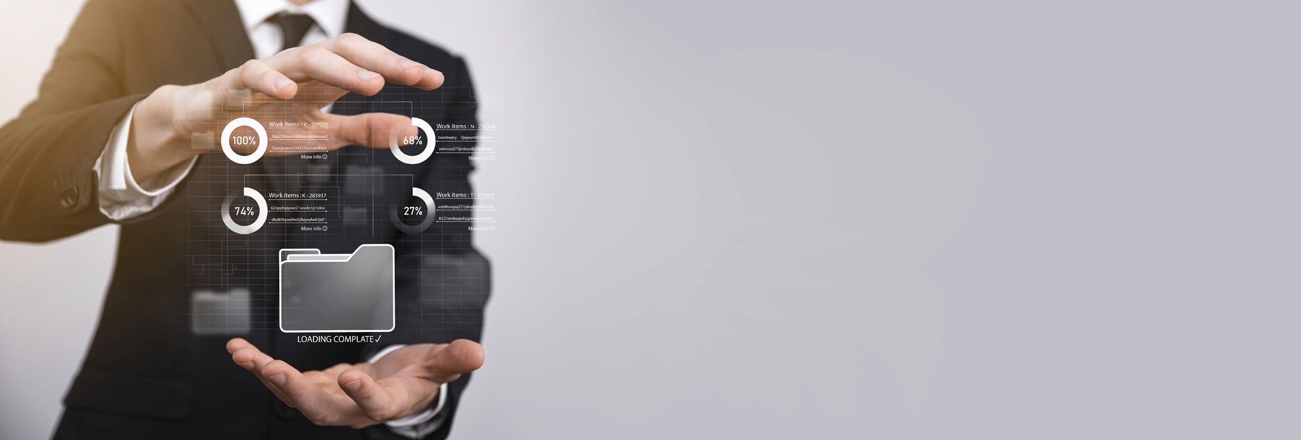 a group of people sitting around a table with laptops