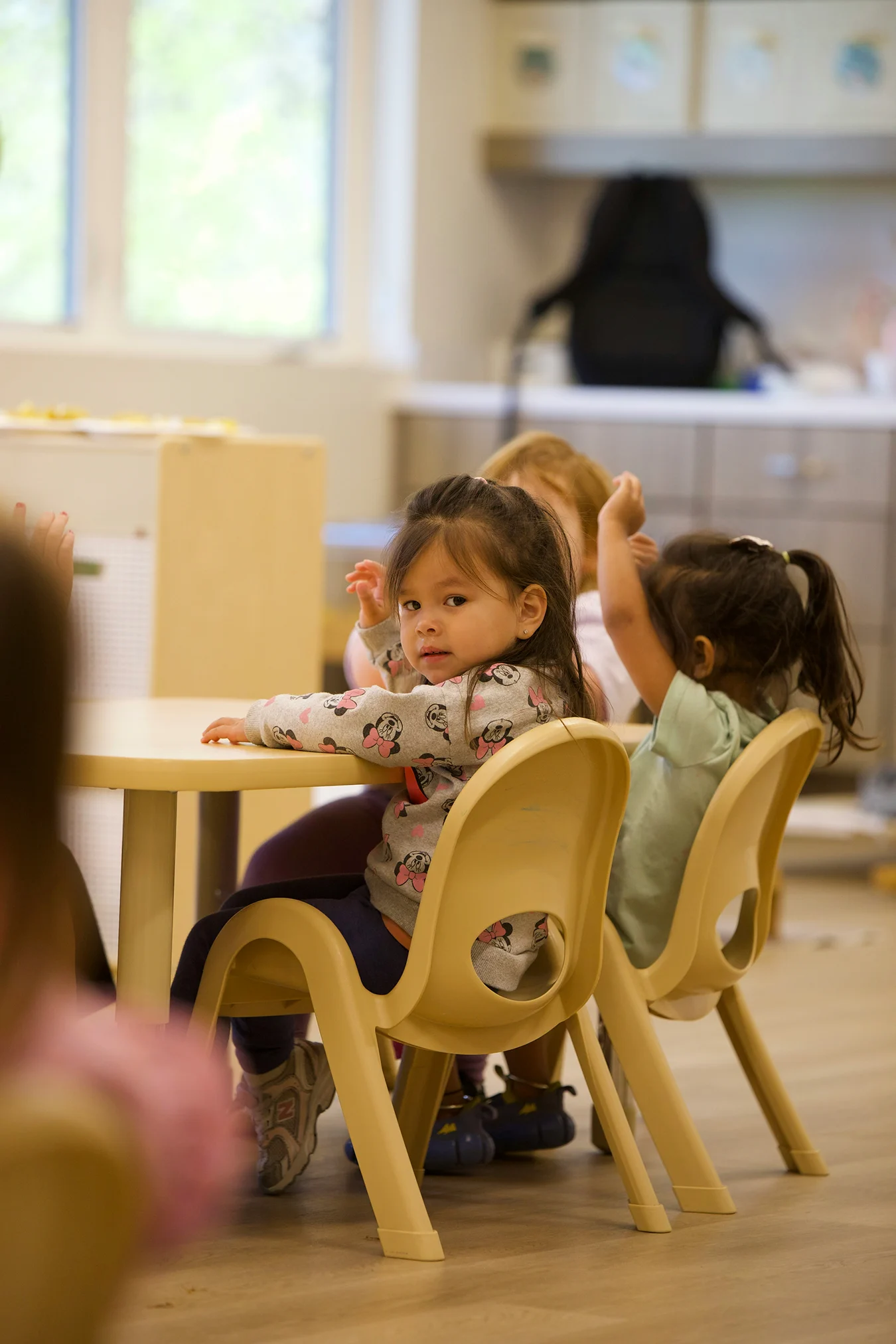 Toddler engaging in hands-on learning activity at a licensed daycare center