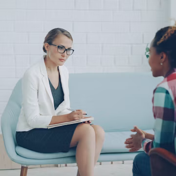 Two women talking in a therapy session