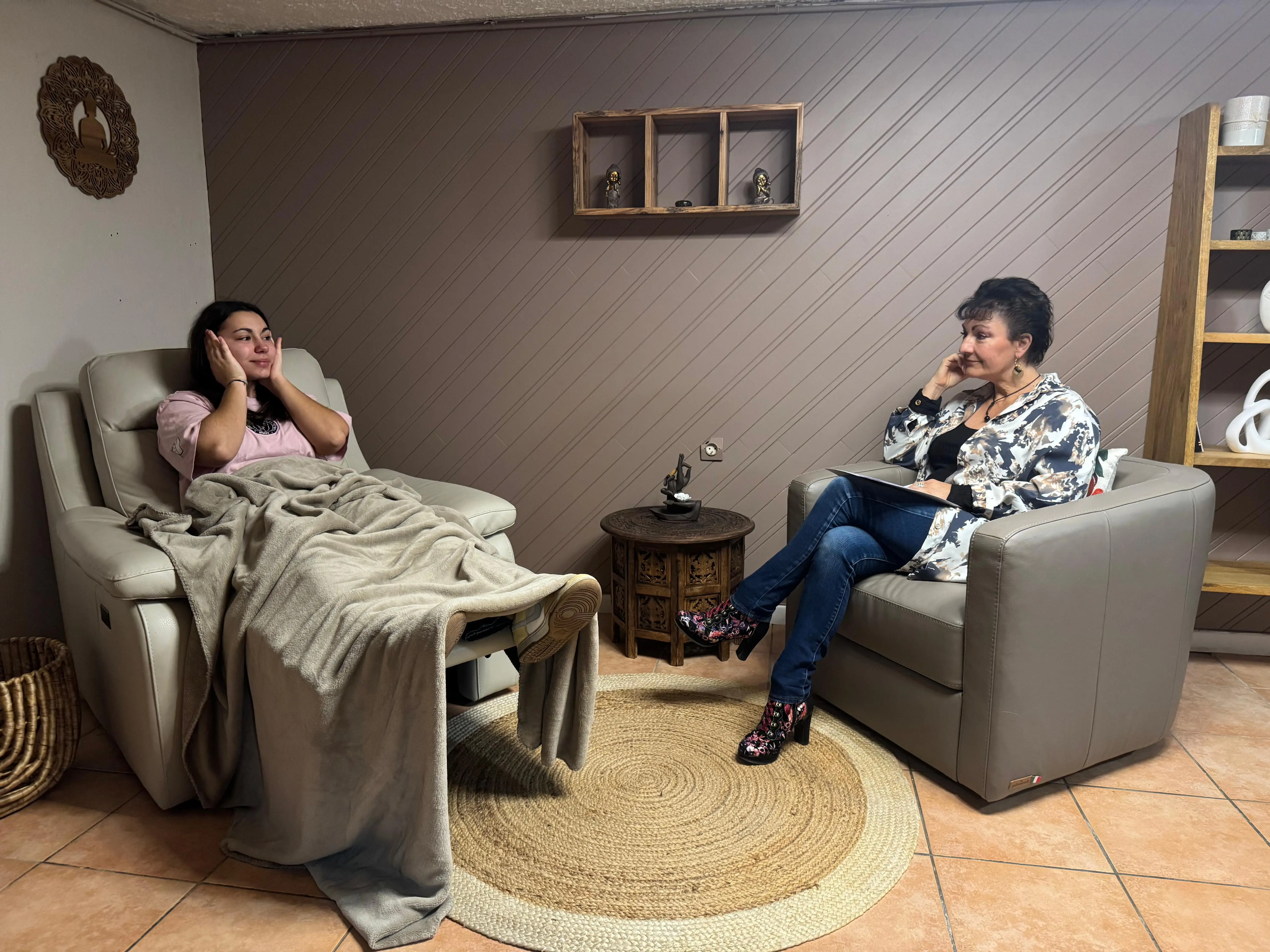 woman looking sideways while holding black laptop computer