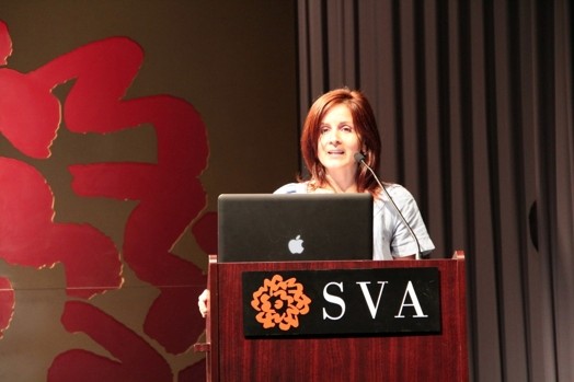a woman giving a speech from a stand in the "designer as" thesis presentation