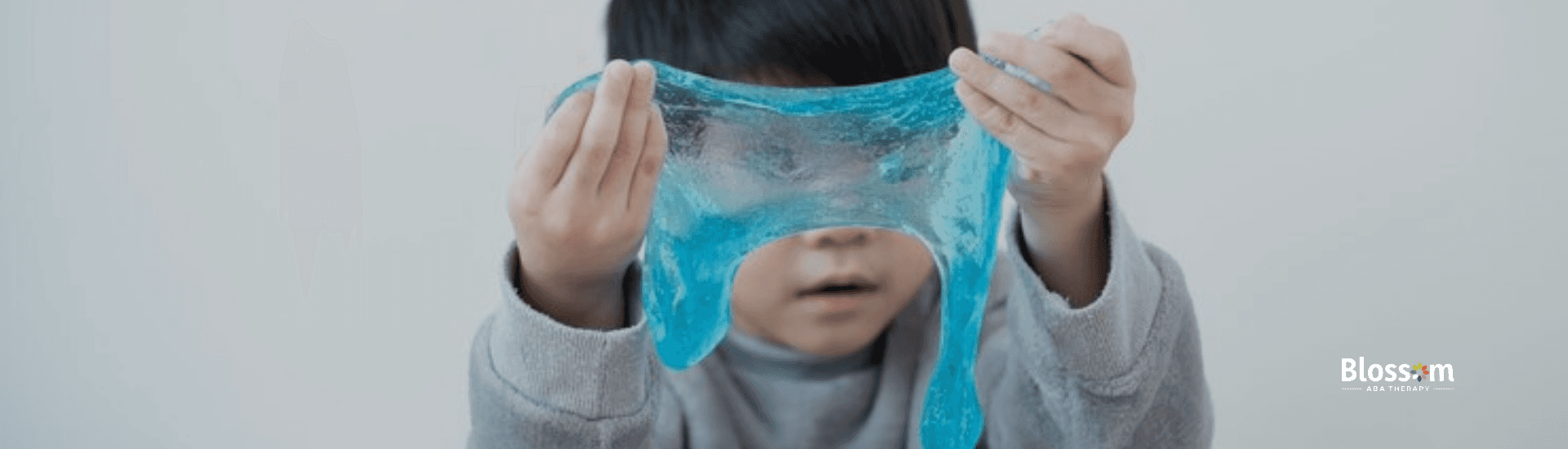 A boy holding up a slime