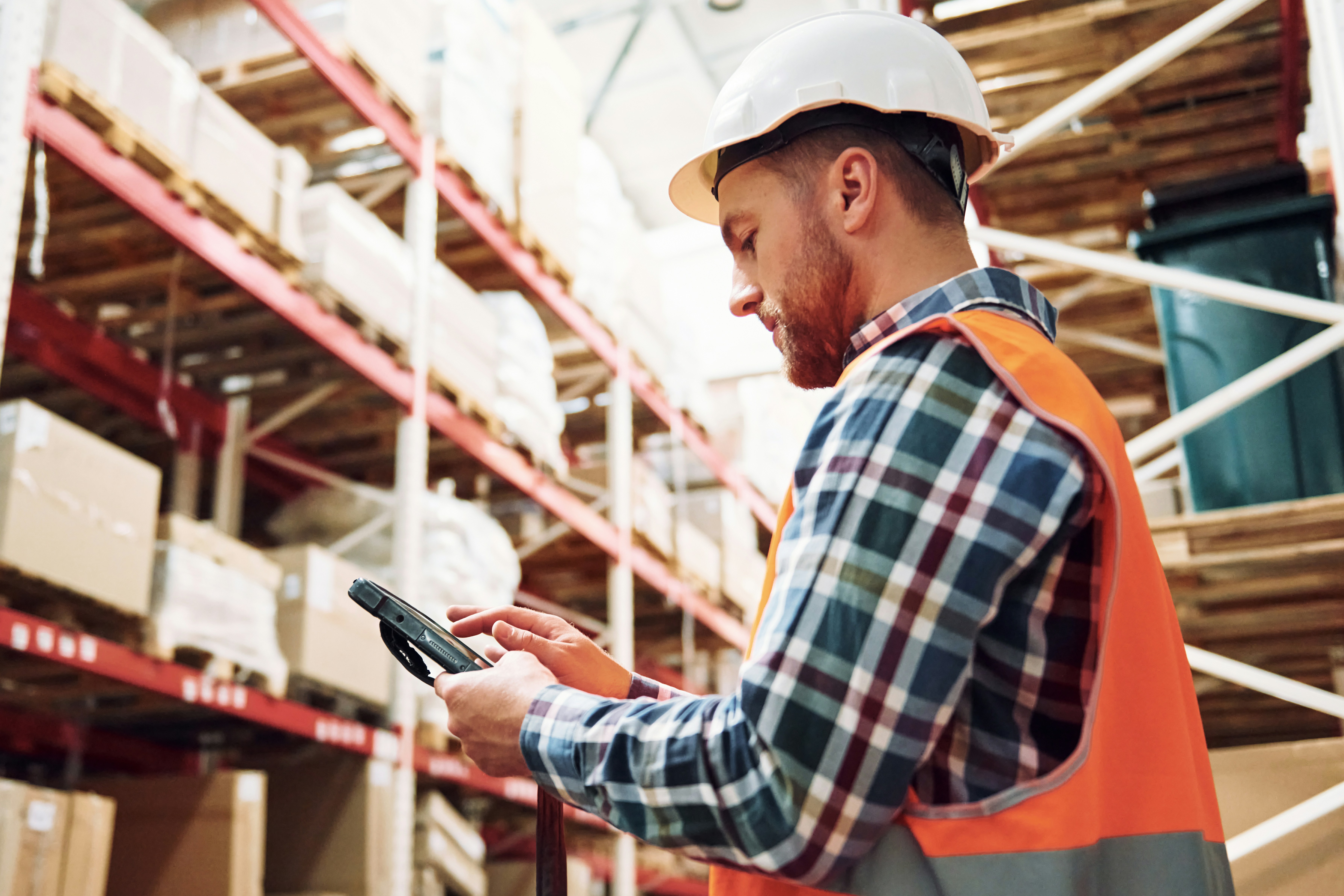 warehouse worker looking at a clipboard