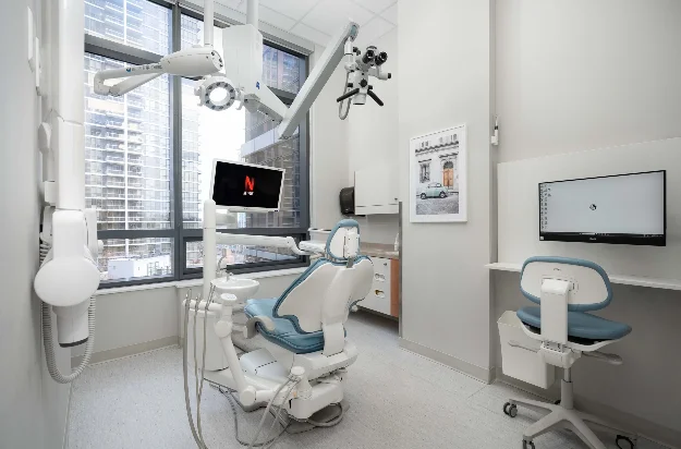 Treatment area with dental chair and dental microscope and entertainment system at at Sovrle Dental Clinic in North York, Ontario: the best dentist in North York, Ontario
