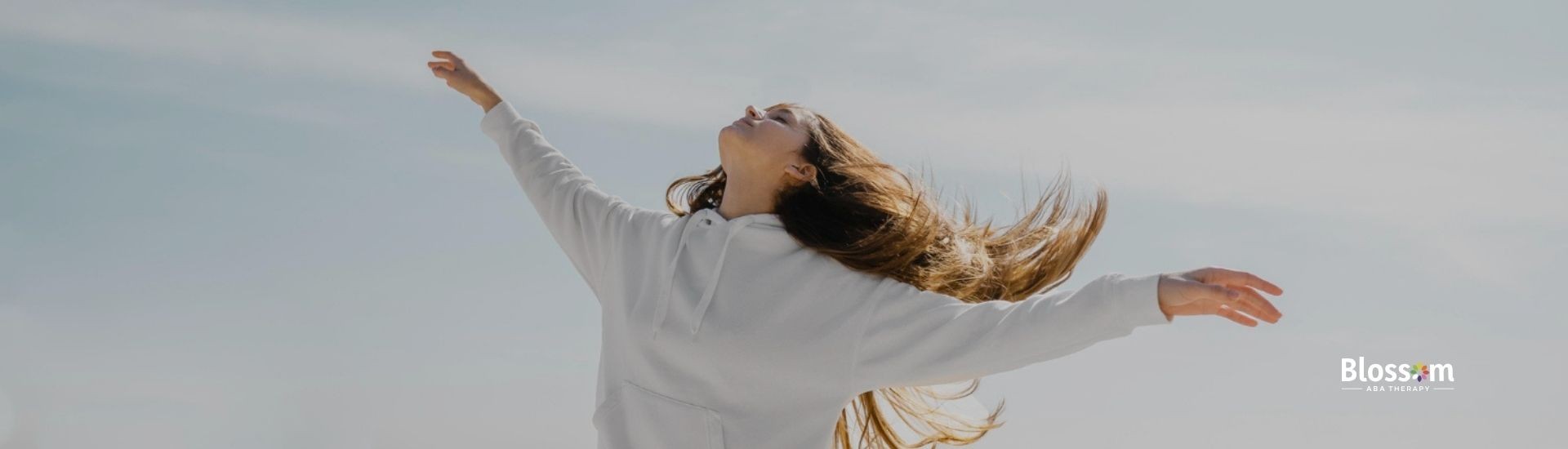 Autistic woman with long hair looking up.