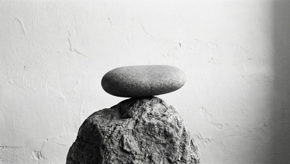 An abstract photograph of a single, perfectly balanced rock formation