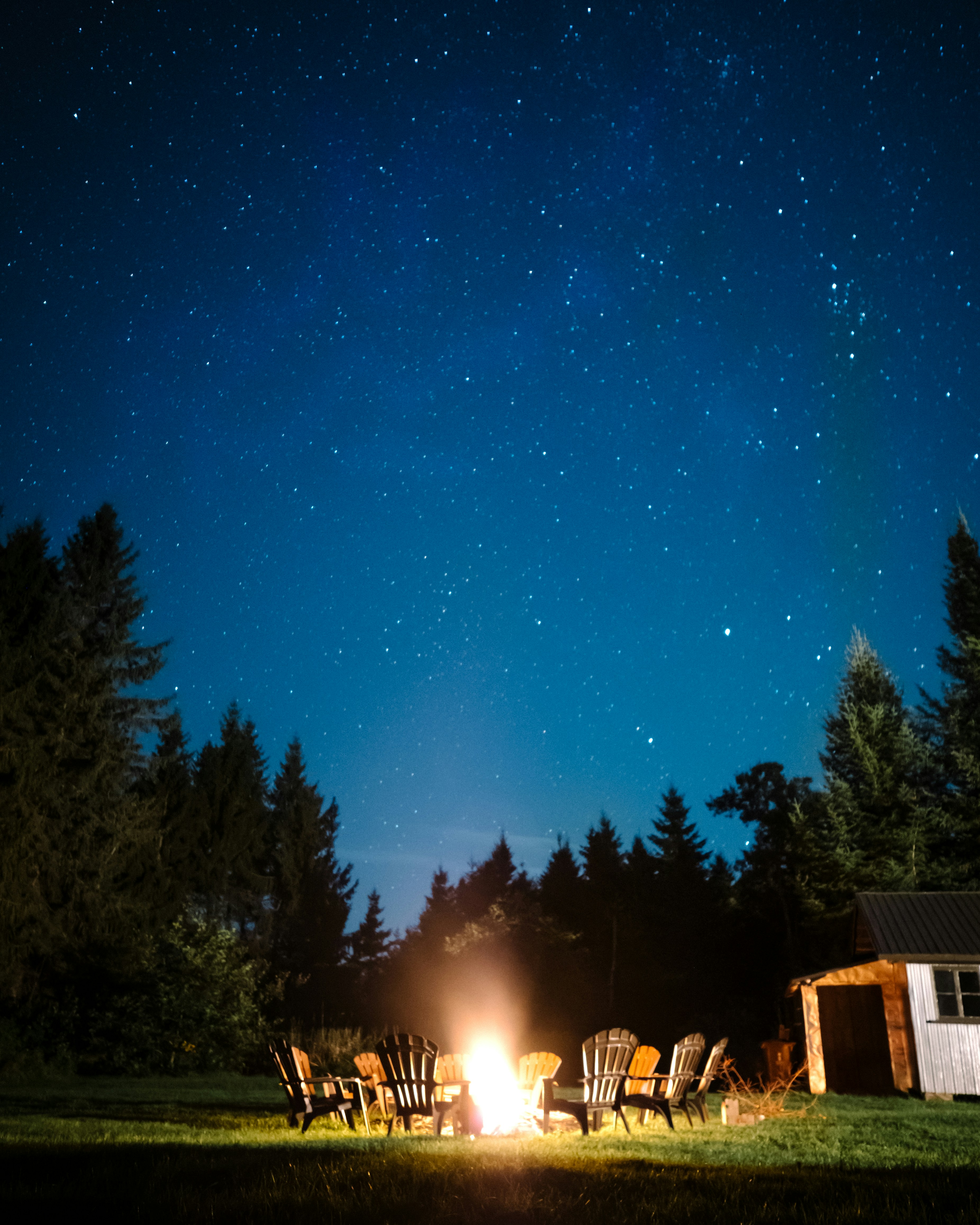 black Adirondack chair under the night sky