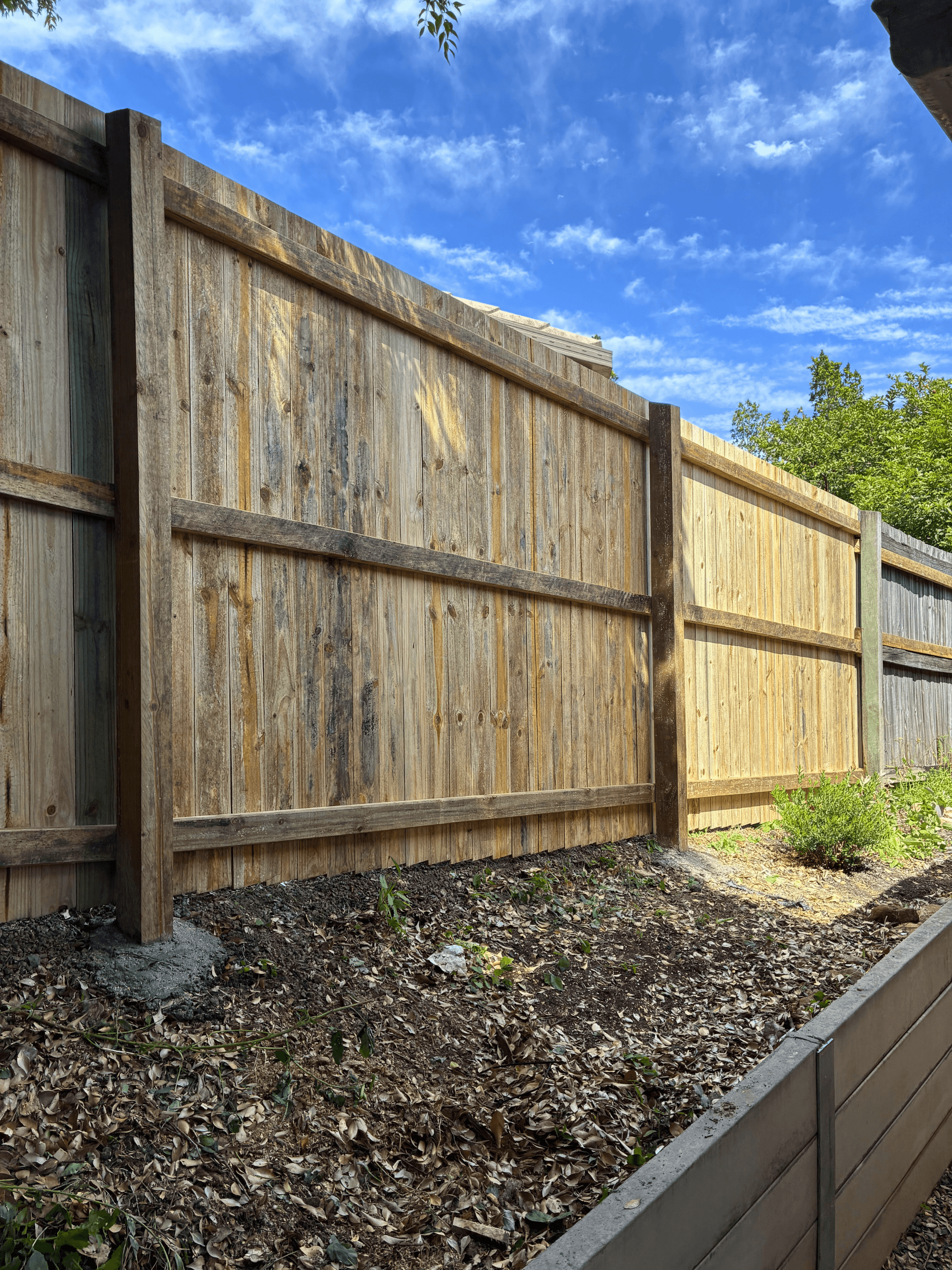 Finished wooden fence on a property maintenance project