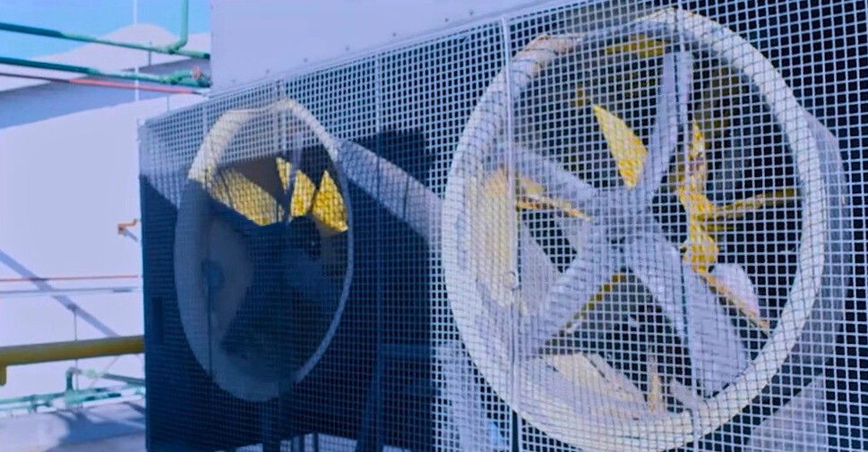 A brick building with two air conditioners on the side of it