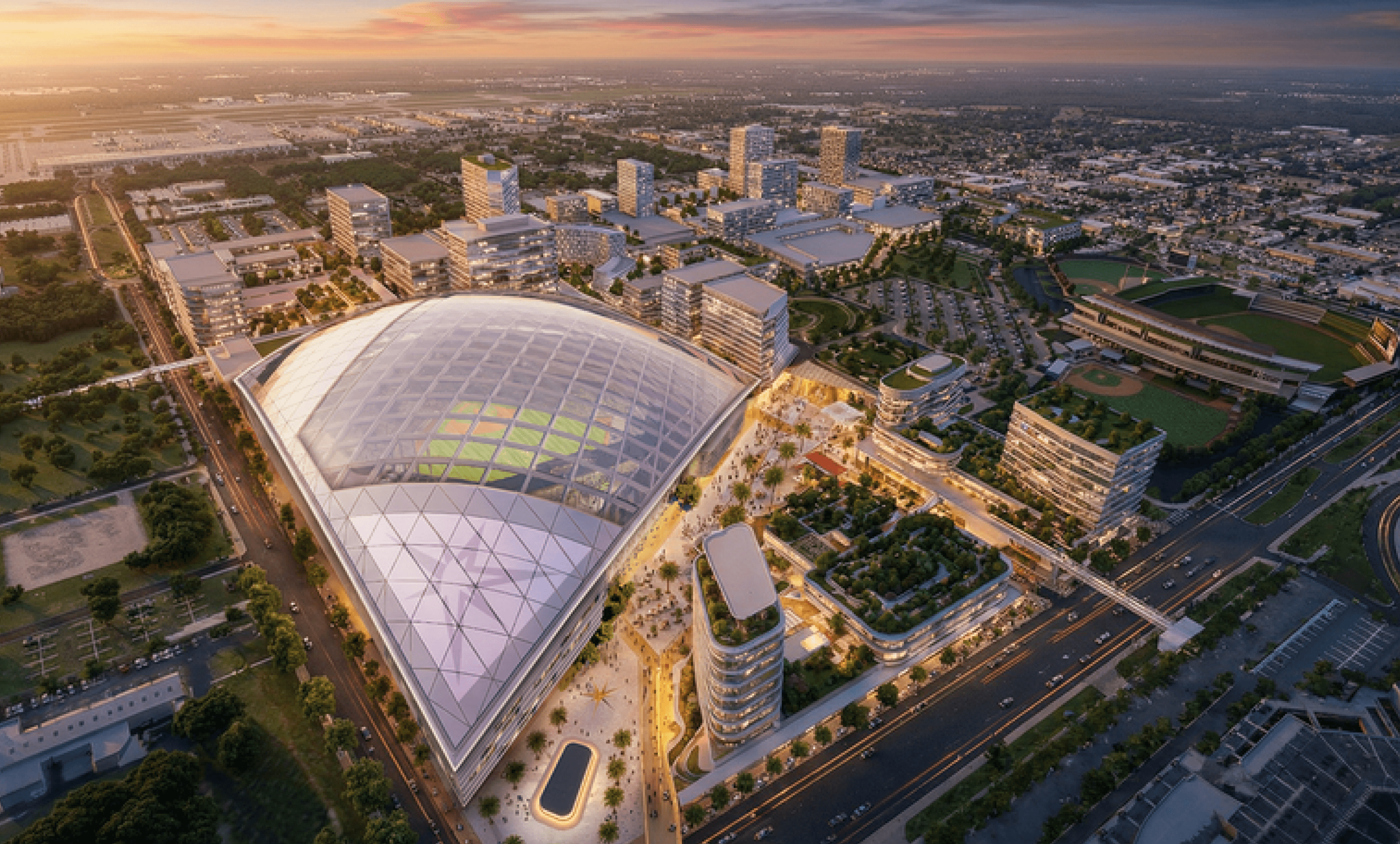 Aerial view of a modern sports stadium with distinctive architecture along a highway corridor