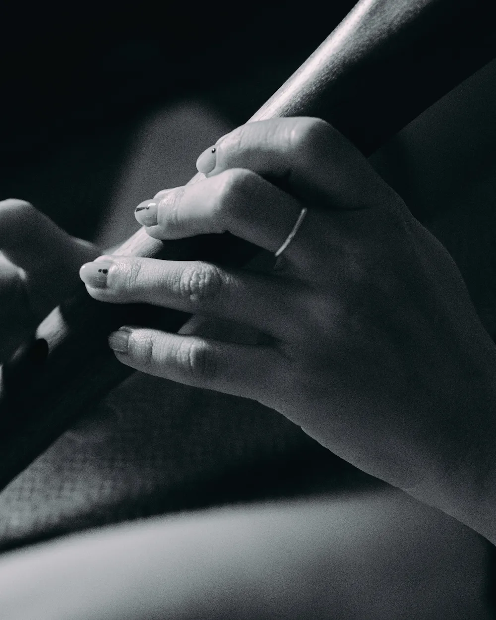 Close-up of hands holding a wooden flute during an intimate meditative ritual experience.