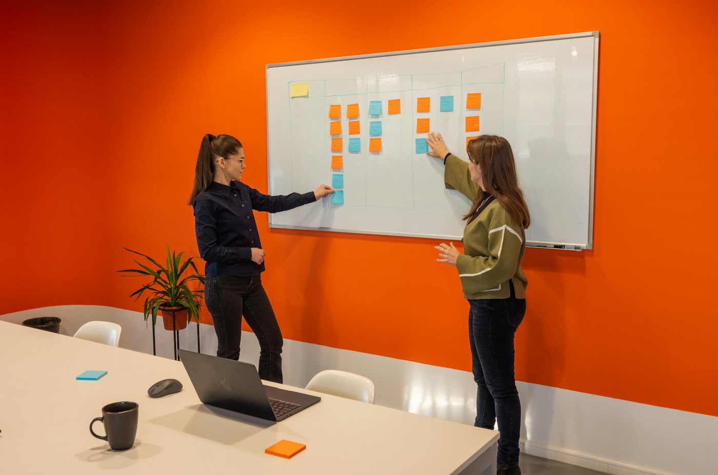 whiteboard with a hand-drawn system architecture diagram in a meeting room