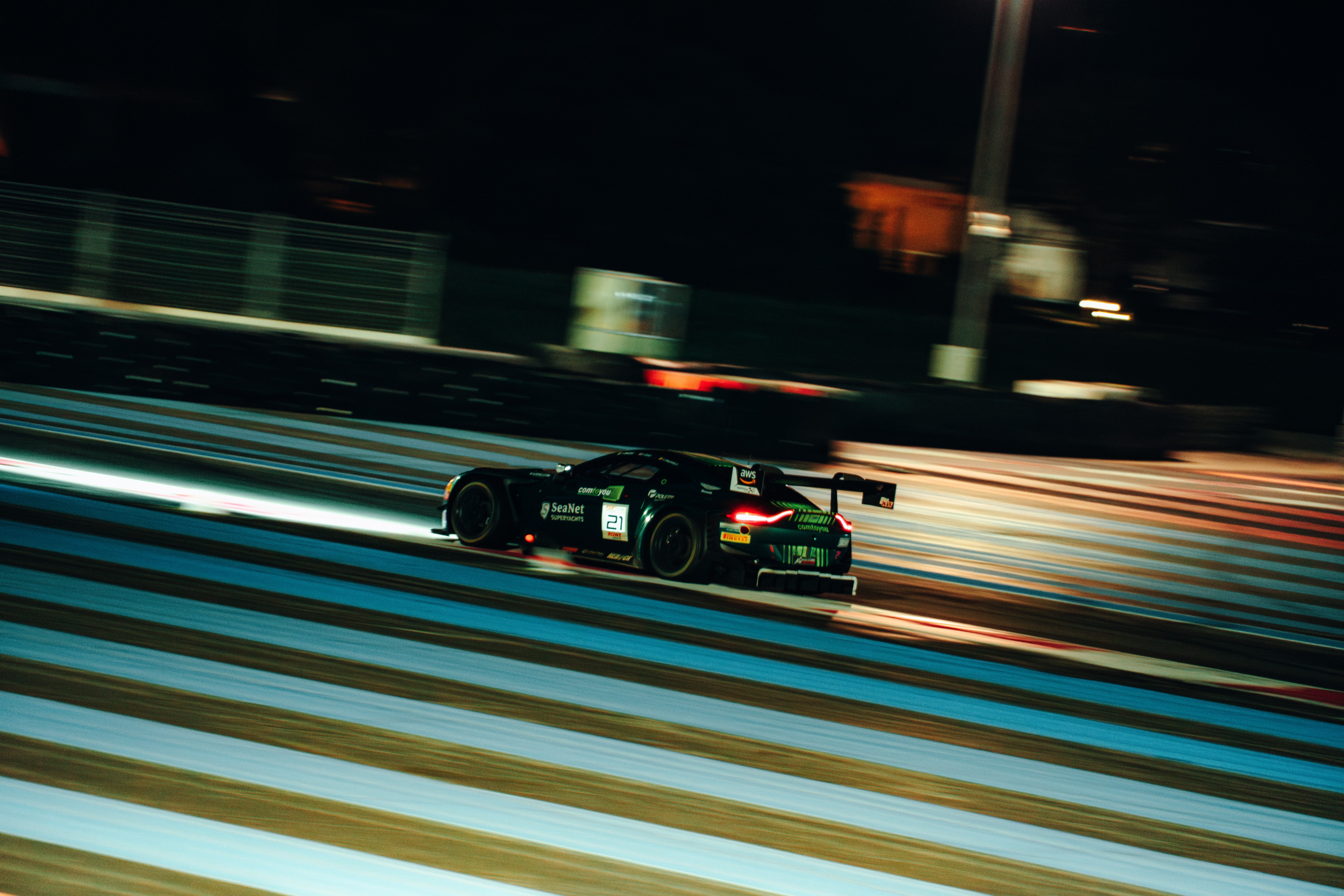 A woman in a black turtleneck has a red streak over her eye with a blurred effect, looking up.