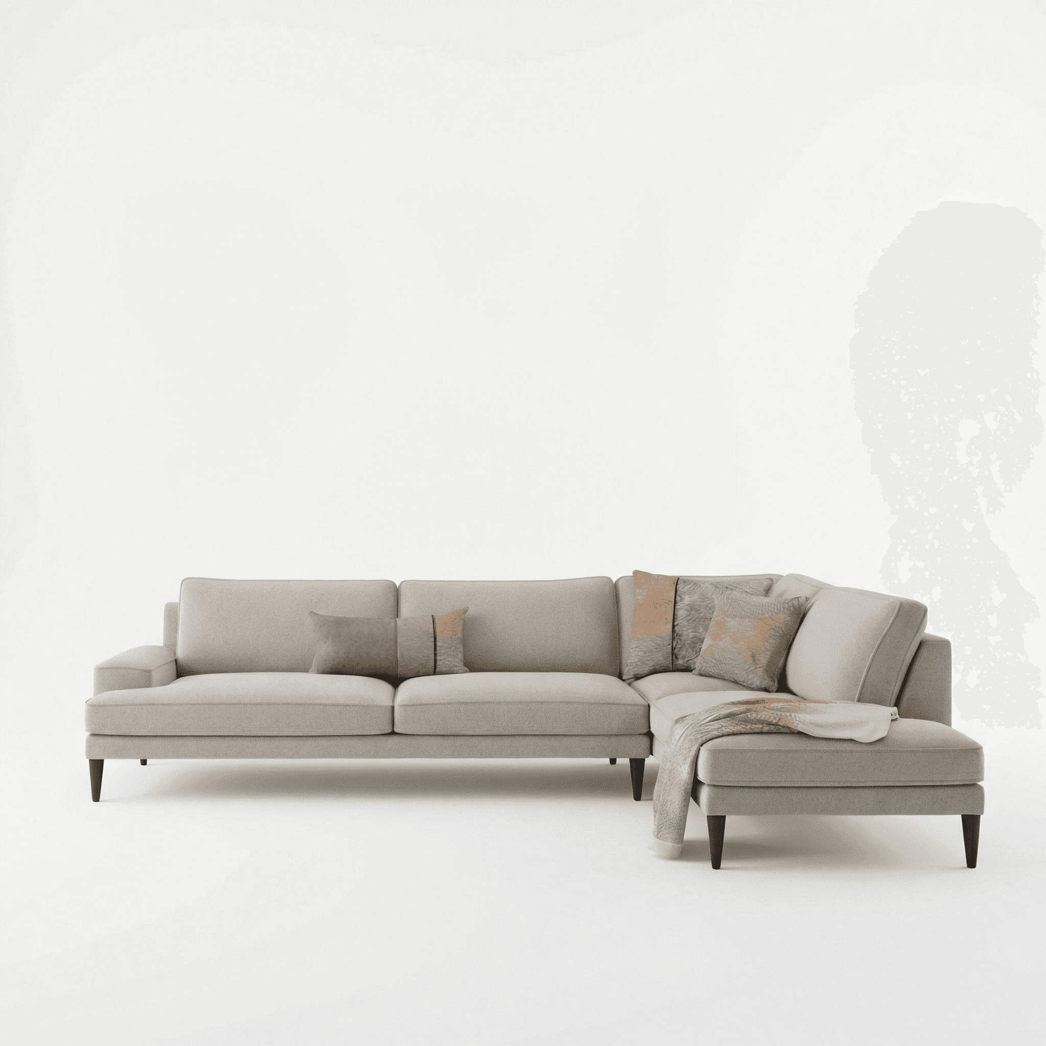 Light‑toned sectional sofa styled against a soft green feature wall