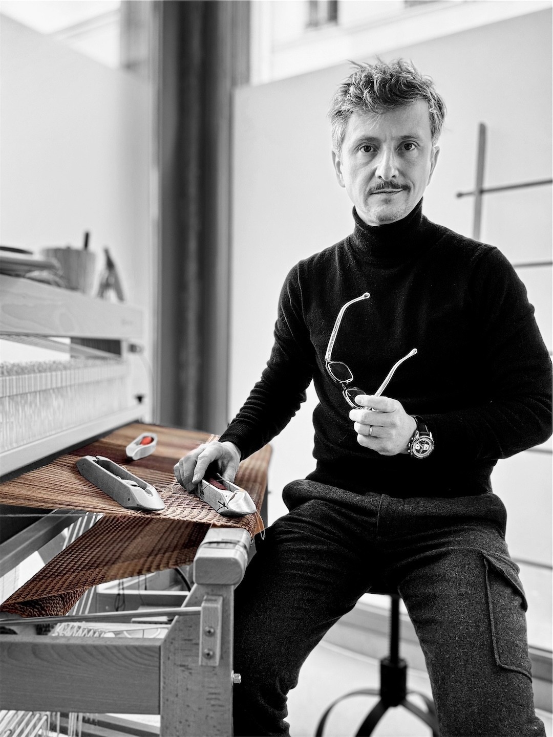 A disco ball hangs from a white ceiling.