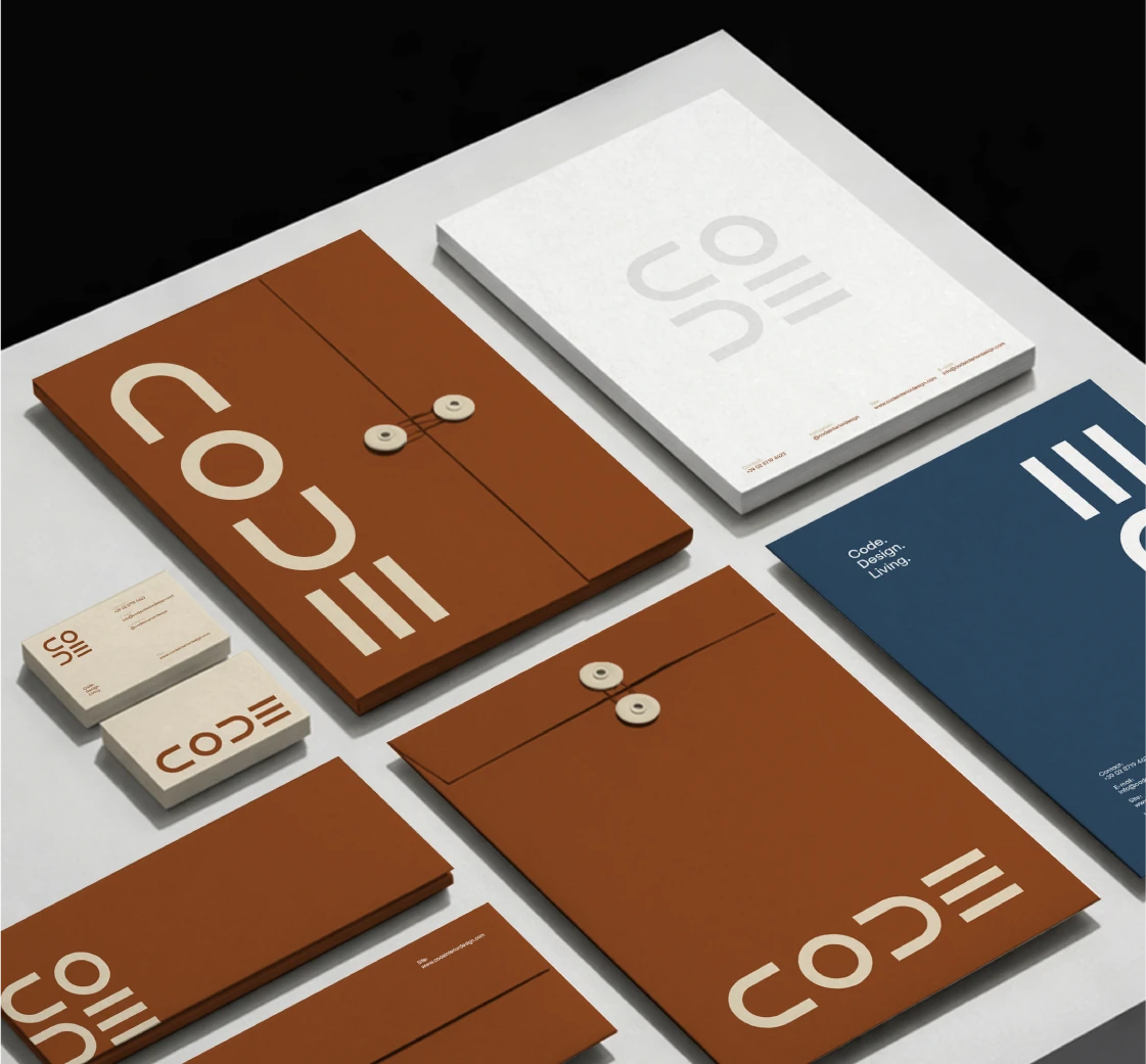 CODE brand stationery system with folders, business cards, envelopes and printed identity materials.