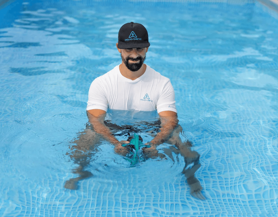 Man performing oblique workout in water with Aqua-Bend FIT disc, side flex exercise
