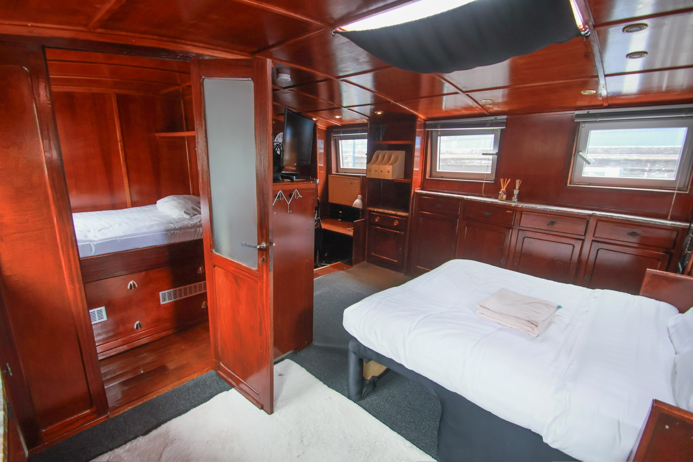 Grey marble bathroom with round mirror and floating sink
