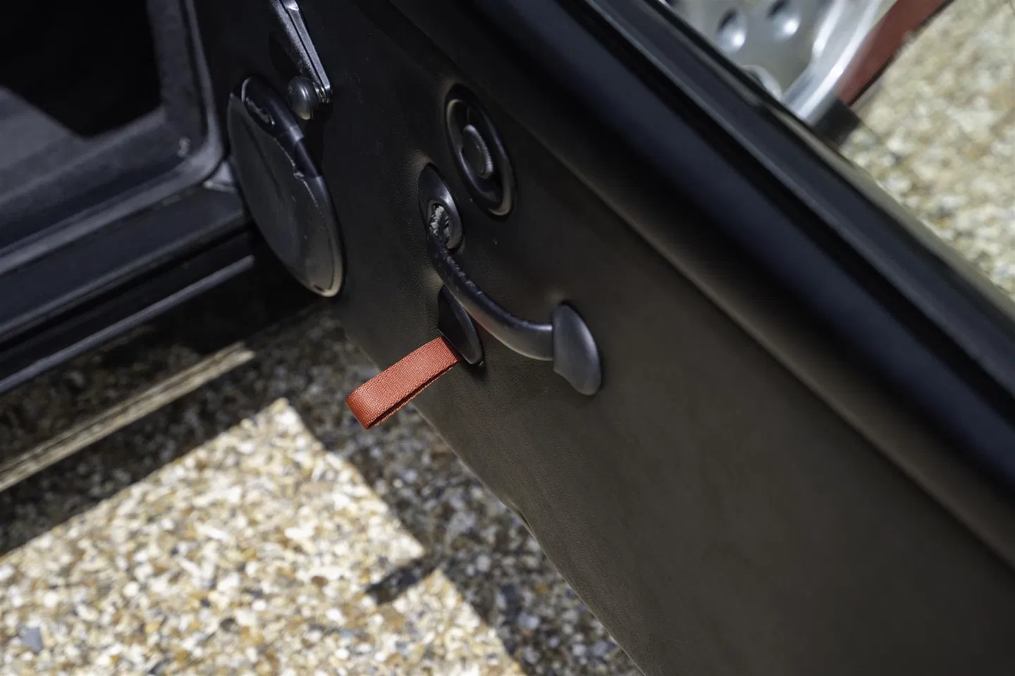Lightweight door card with red fabric pull strap