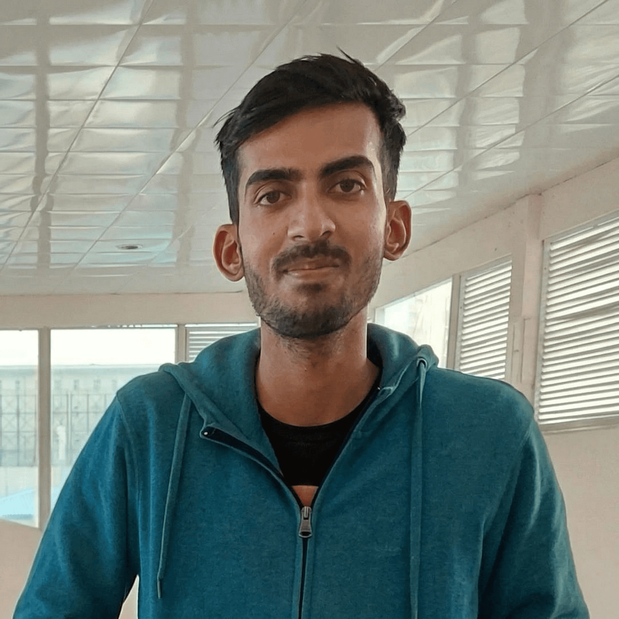 Smiling man with glasses poses for a portrait.