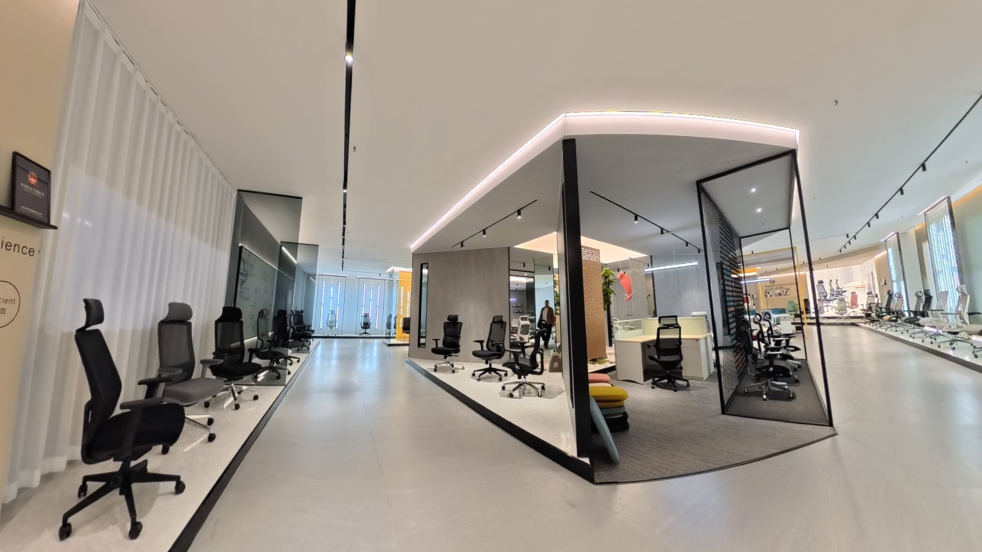 Modern ergonomic office chair showroom at Foshan T-Chod Furniture Co., Ltd., featuring a wide range of mesh executive chairs, task chairs, and contemporary workstation displays in a sleek, minimalist interior with professional lighting.