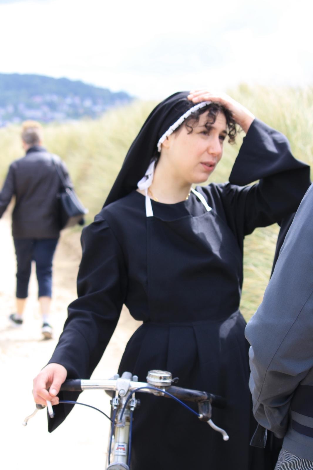 Woman in pink leather jacket crouching outdoors at night