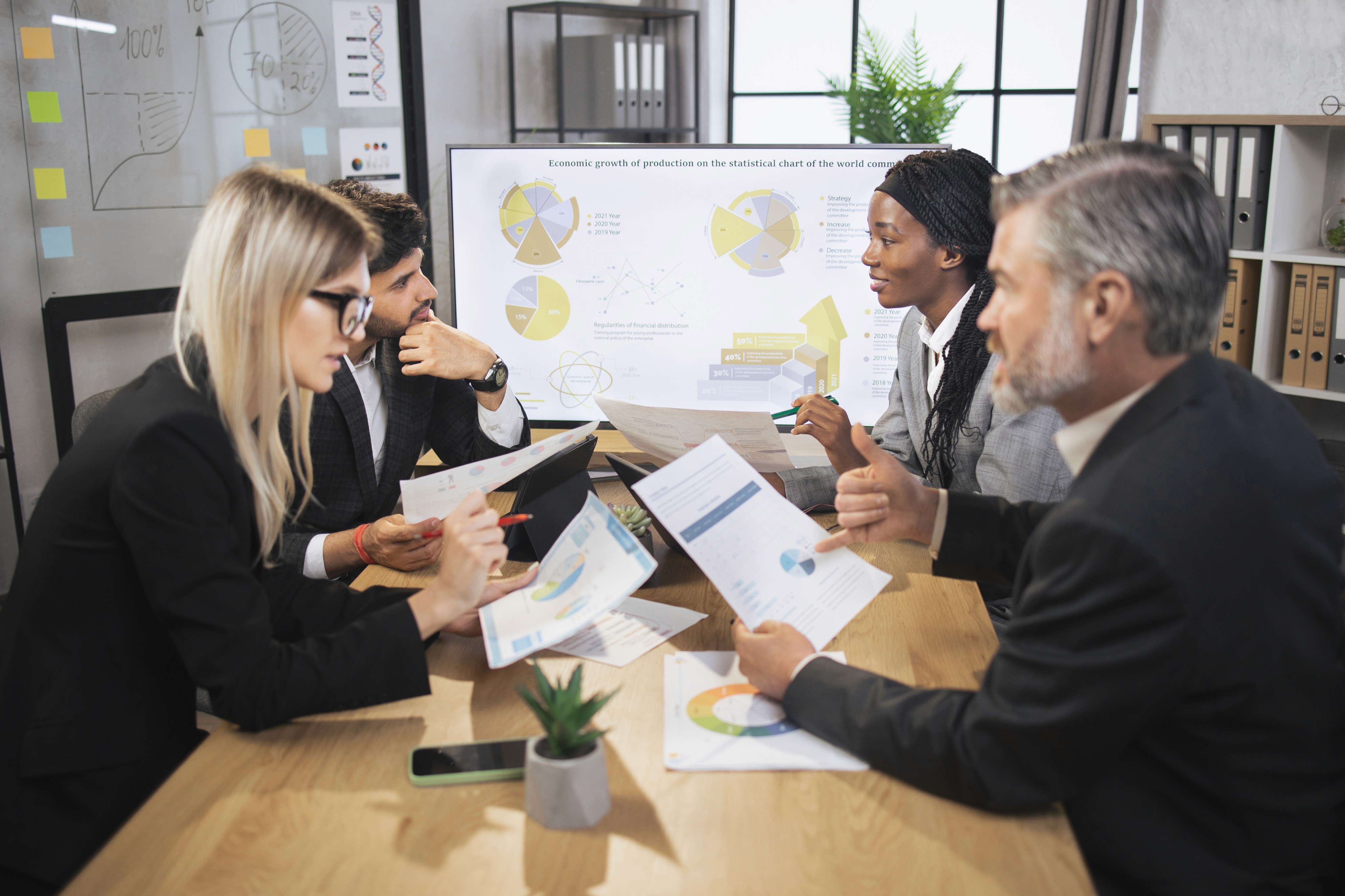 Business meeting with four people at conference table